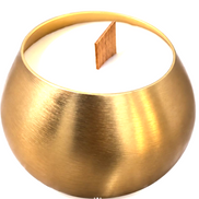 Close-up of an asymmetric brushed-gold metal candle jar