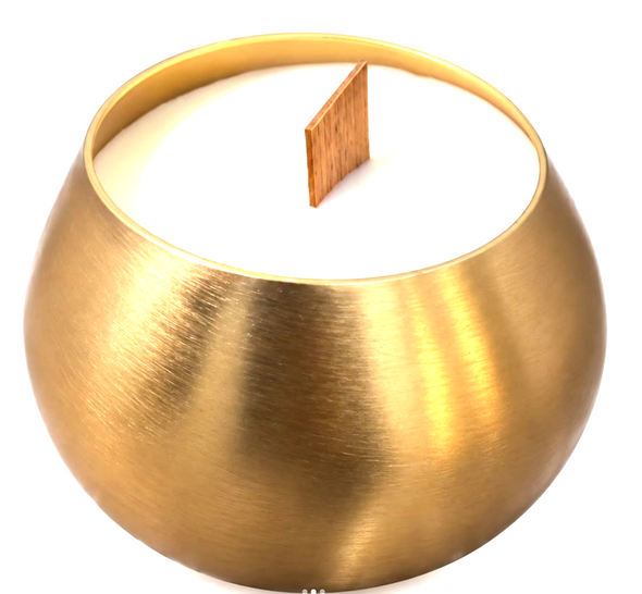 Close-up of an asymmetric brushed-gold metal candle jar