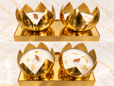 Two gold lotus-shaped candles styled on a gold tray, shown from two angles. Candles sold individually; tray not included.