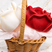 Red and white floral wax candles arranged in a woven basket