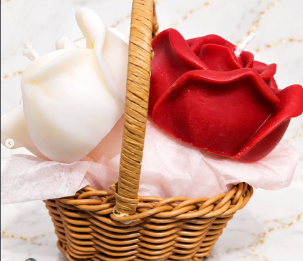 Red and white floral wax candles arranged in a woven basket