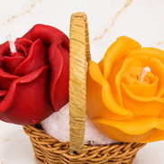 Red and yellow floral wax candles arranged in a woven basket