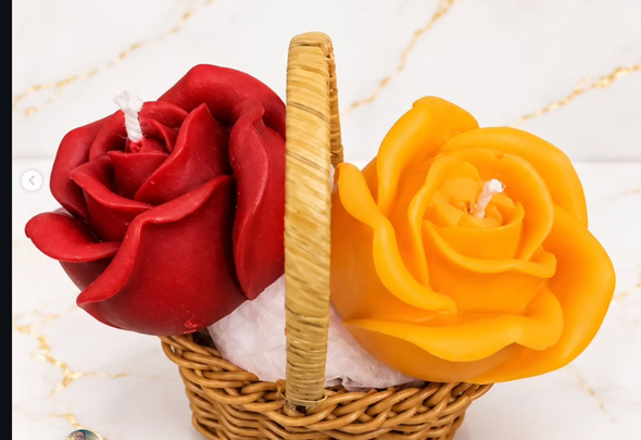 Red and yellow floral wax candles arranged in a woven basket